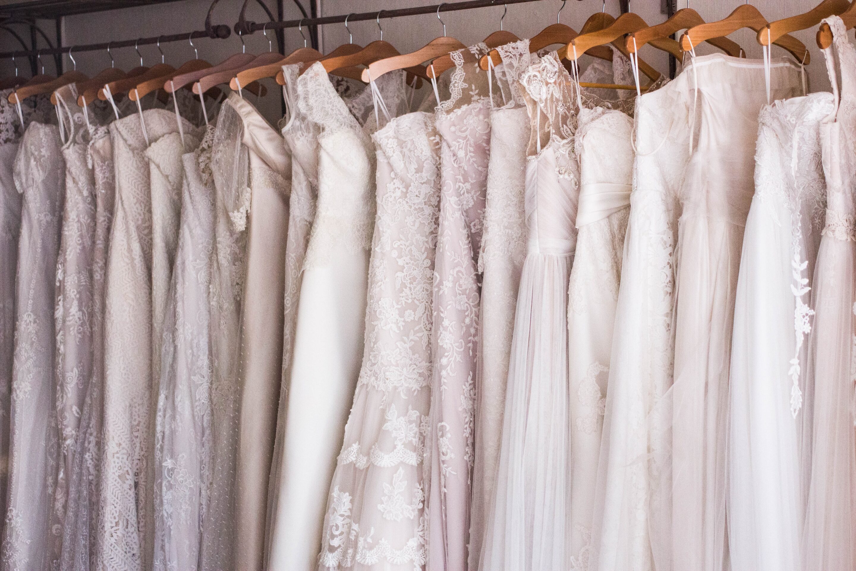 Beautiful dresses neatly hung in a closet