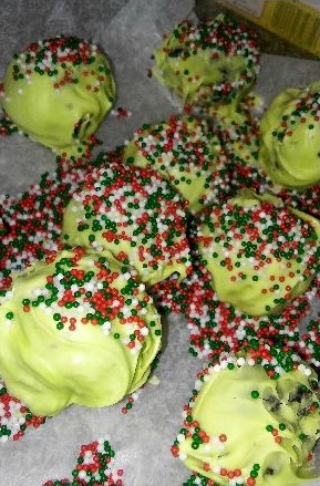 Grinch truffles with green chocolate and sprinkles
