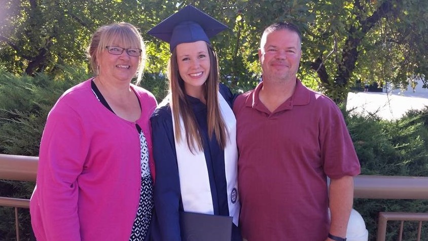 MaLee with parents at college graduation