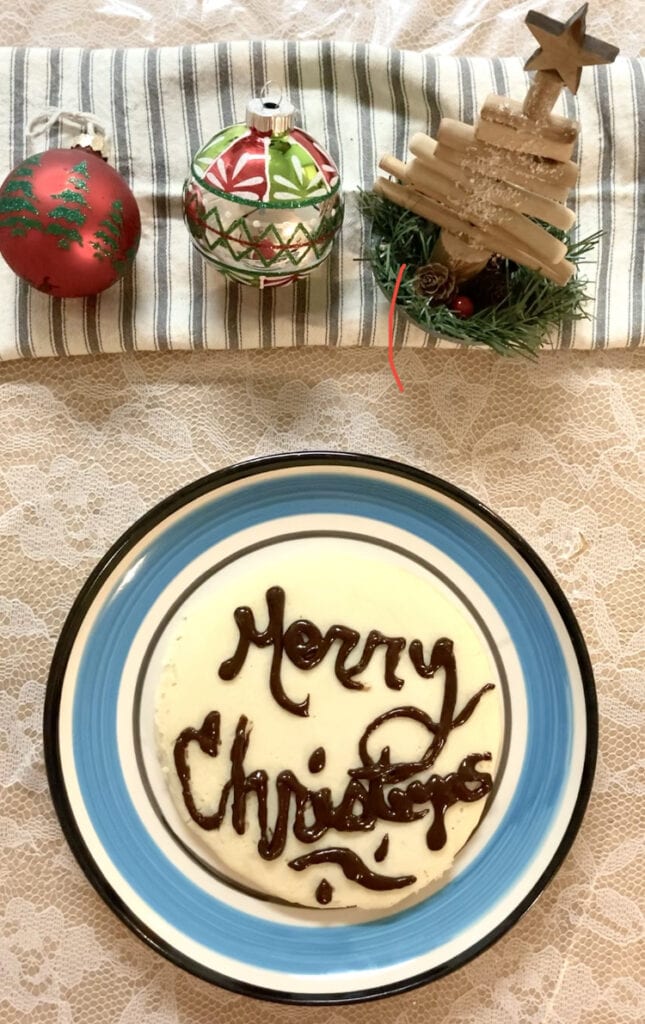 A pancake with Merry Christmas written in chocolate syrup