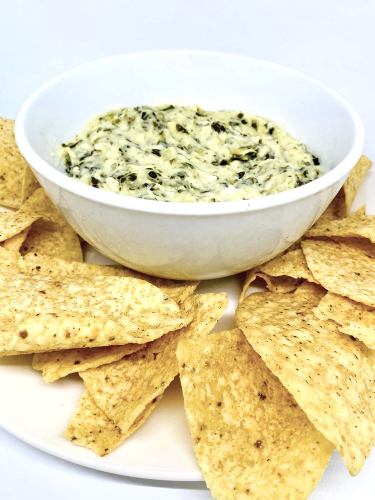 Instant Pot Spinach Artichoke Dip in a Bowl with tortilla chips