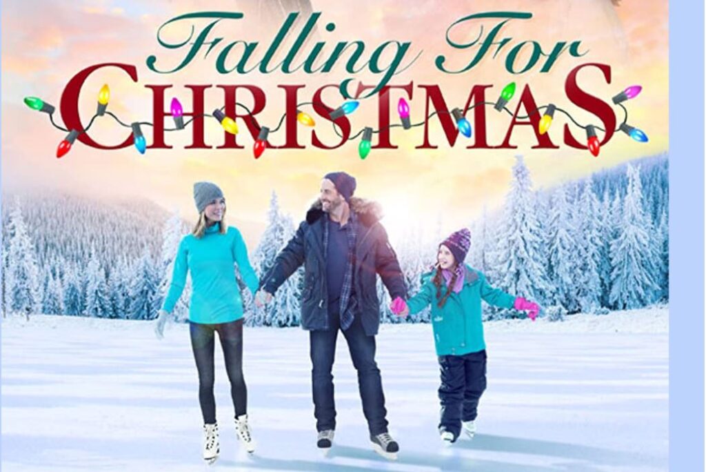 A man and woman and young girl in a blue coat skate together near pine trees in the holiday romance movie Falling for Christmas