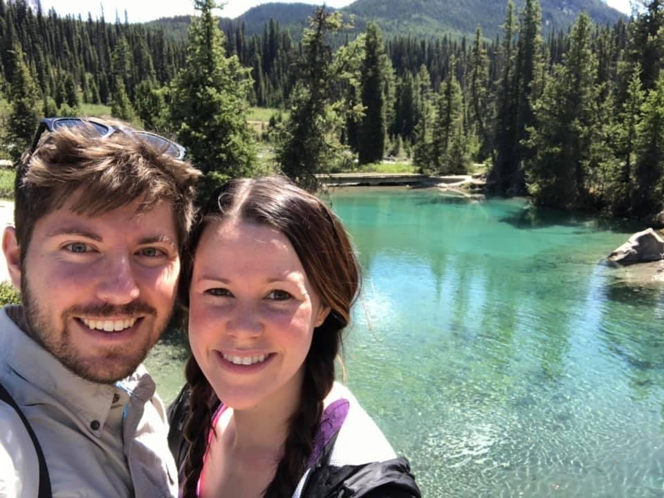 Husband and wife pose by the beautiful scenery of Banff National Park