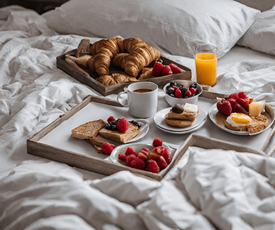 beautiful breakfast in bed with pastries, fruit, eggs, and juice to make a great sense of smell gift